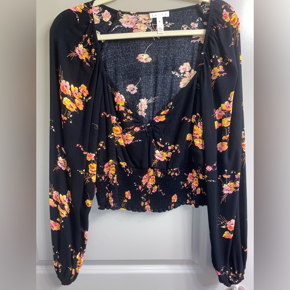Floral black shirt. Bell sleeves. This shirt is slightly cropped. Very stretchy